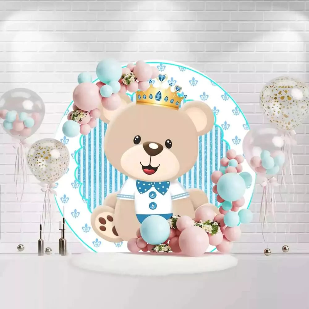 Round baby bear baptism backdrop with crown, blue stripes, and floral accents