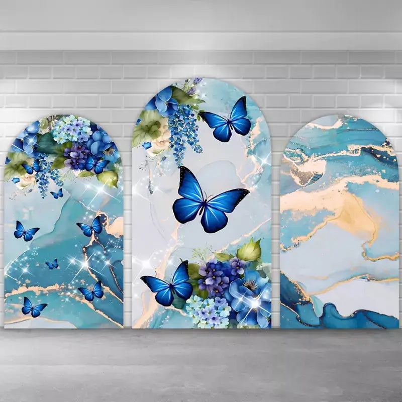 Elegant blue-and-gold marble party backdrop kit: center arch with large sapphire butterflies on pale geode texture, side arches with teal/navy marble, florals, and scattered butterflies—ideal for photo booths and dessert tables.