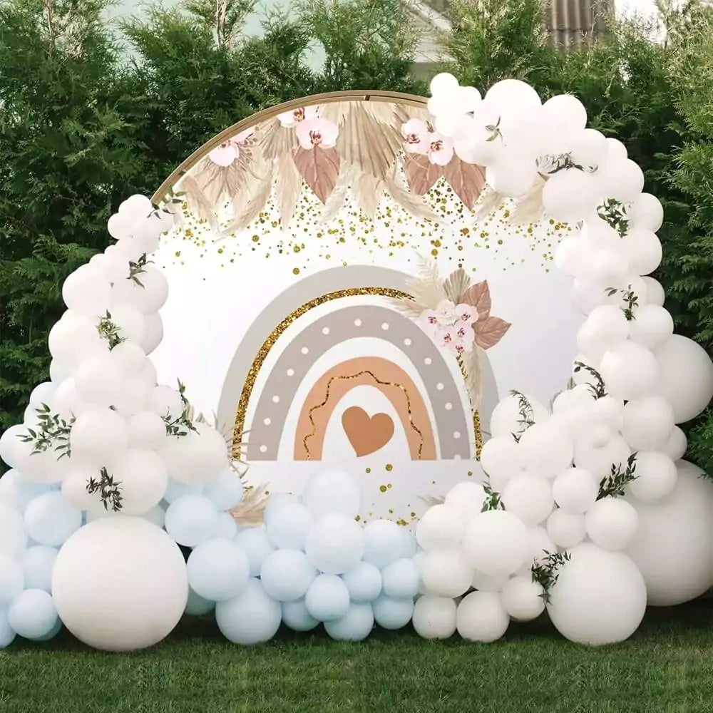 Soft pastel boho rainbow baby shower backdrop with blush pink flowers