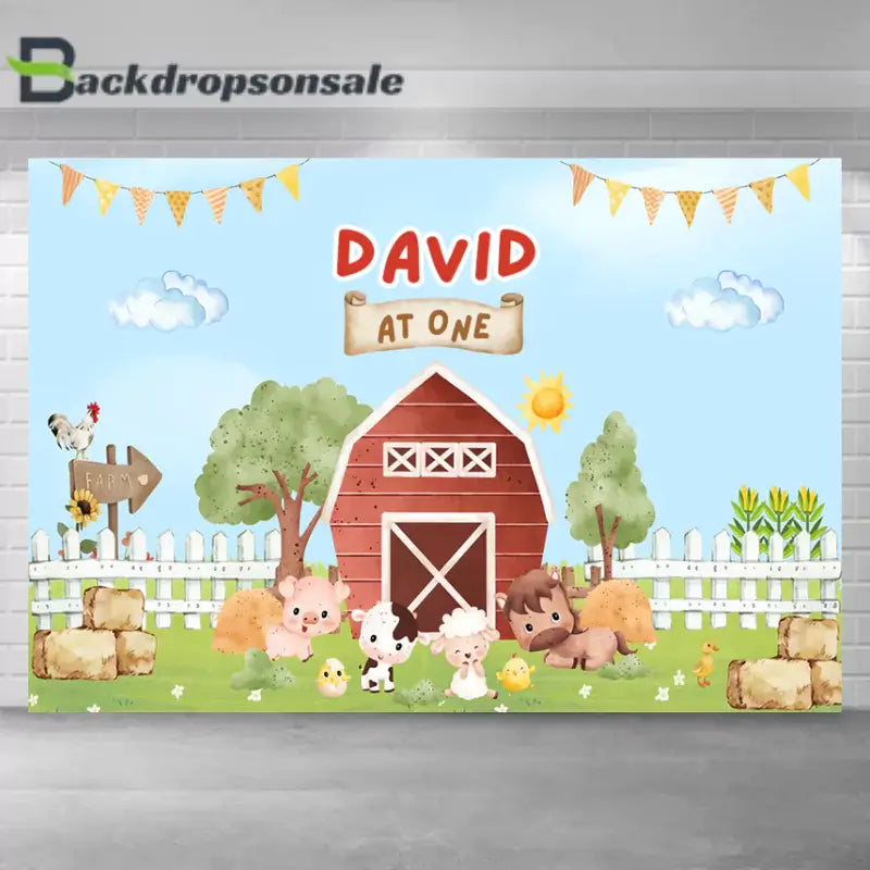 Farm-themed birthday backdrop featuring a red barn, cute farm animals, and the text 'David at One.