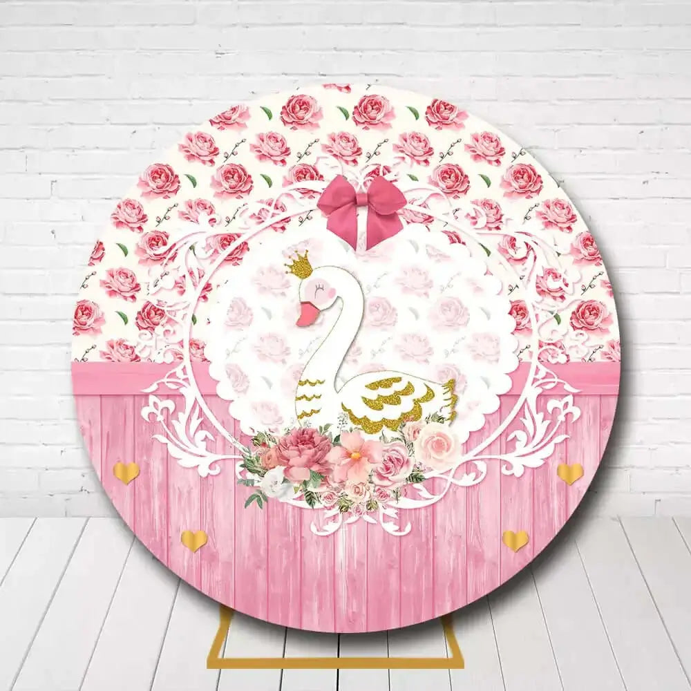 Pink and gold swan round backdrop with flowers for birthday or baby shower