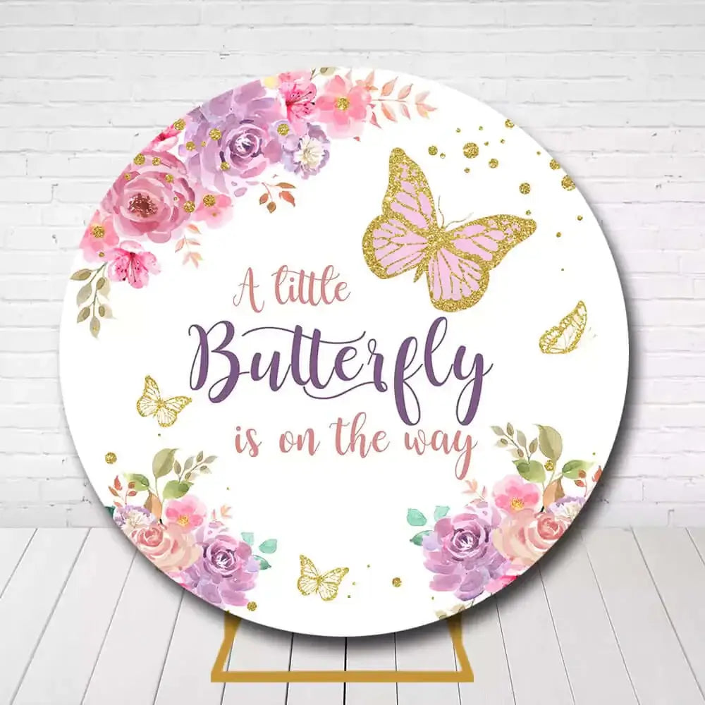 Baby shower circle backdrop with floral accents and "A little Butterfly is on the way" message