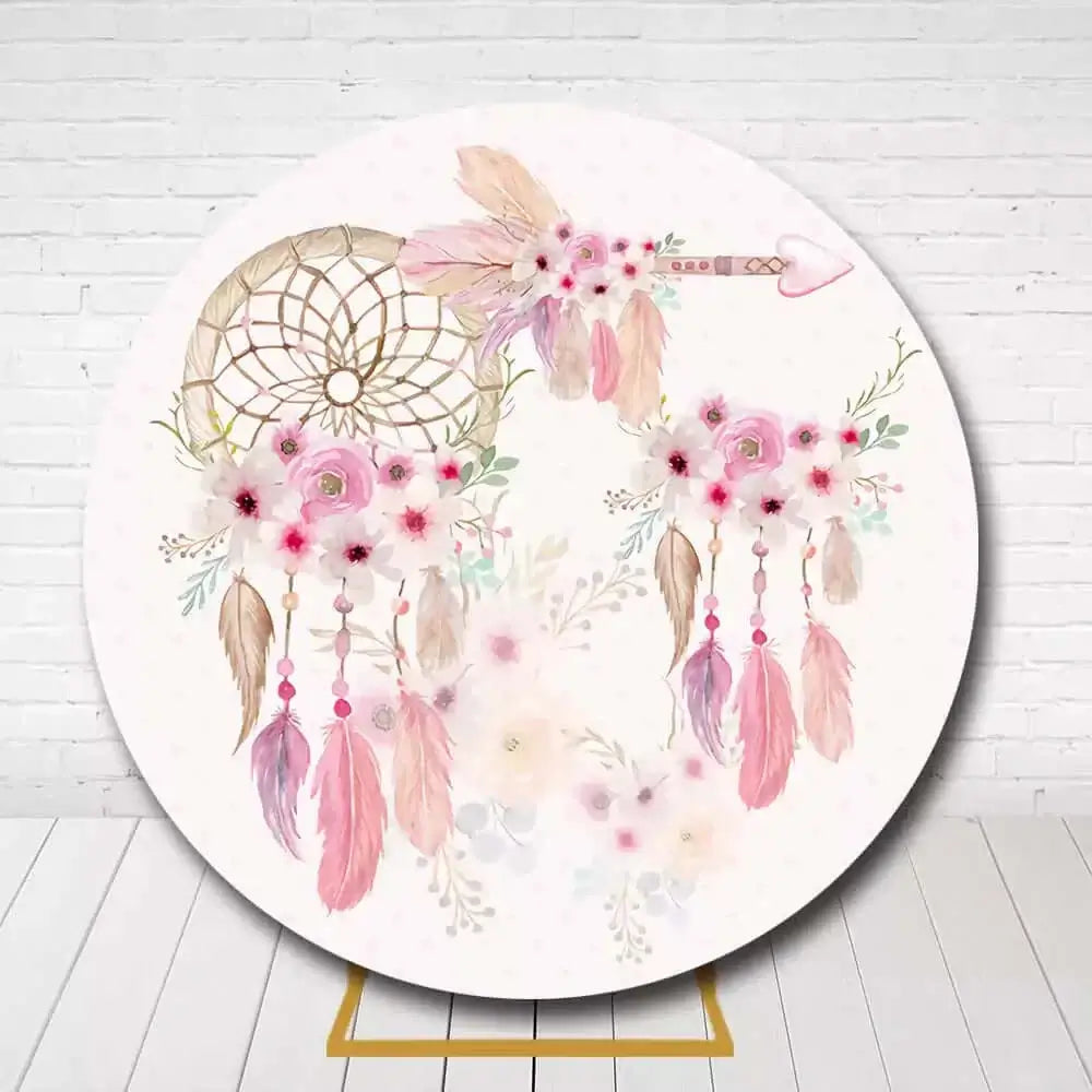 Bohemian-style round backdrop with soft pink feathers and floral dreamcatcher for girls' celebration