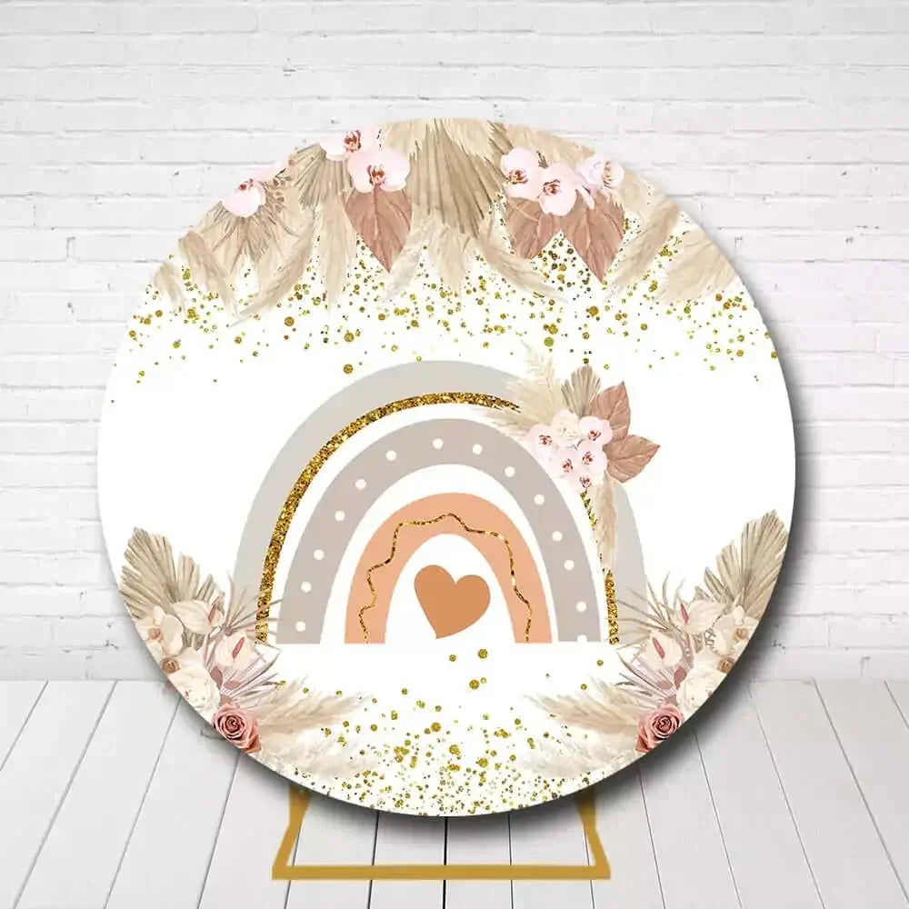 Boho-style rainbow backdrop for baby shower with floral and gold accents