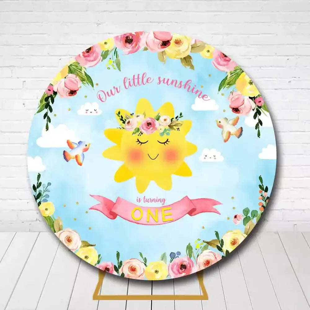 One-year-old birthday backdrop featuring a smiling sun, floral decorations, and playful birds with text "Our Little Sunshine is Turning One"