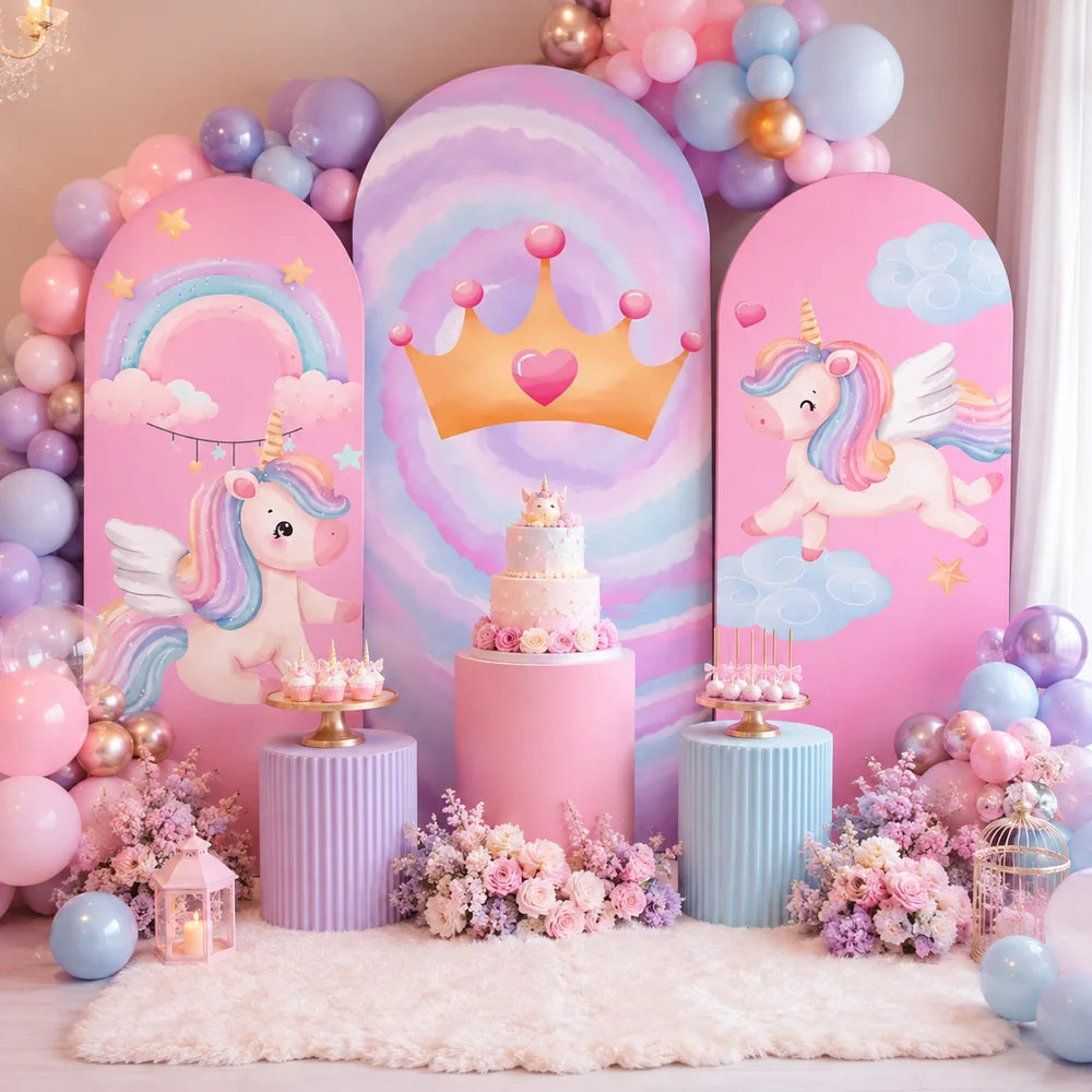 Pastel unicorn princess party set with three arch backdrop covers featuring winged unicorns, rainbow clouds, stars and a golden crown on a pink and lavender background.