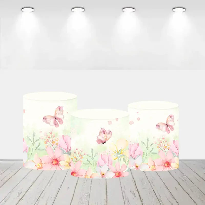 Set of three cylinder covers with floral and butterfly designs in pink and peach tones.