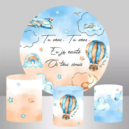 A whimsical backdrop set featuring a round backdrop with hot air balloon and cloud designs, accompanied by three cylinder covers in matching blue and orange colors.