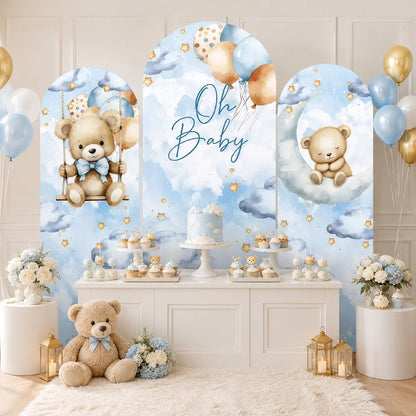 Blue teddy bear Oh Baby party set with three arch backdrop covers featuring watercolor clouds, stars, balloons, a teddy bear on a swing and a sleeping bear on the moon.