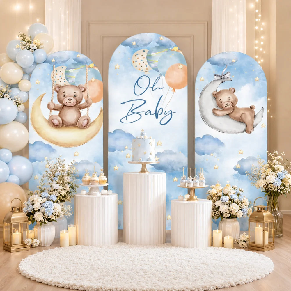Blue teddy bear baby shower set with three arch backdrop covers featuring Oh Baby lettering, watercolor clouds, stars, balloons and bears on crescent moons.