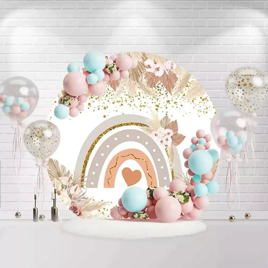 Boho rainbow baby shower backdrop with floral accents and gold glitter