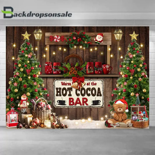 Christmas-themed hot cocoa bar backdrop featuring decorated trees, rustic wooden accents, and festive holiday decor.