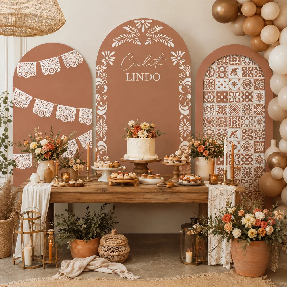 Warm boho Mexican party set with three arch backdrop covers featuring white papel picado lace details, Cielito Lindo lettering, folk floral motifs and decorative tile patterns.