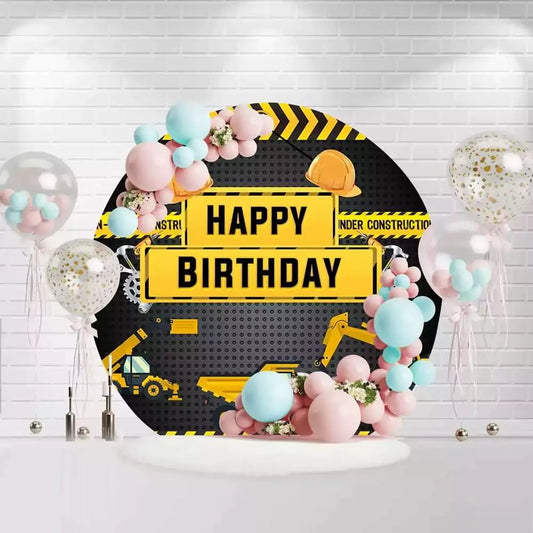 Round construction birthday backdrop with hard hats, trucks, and yellow caution tape