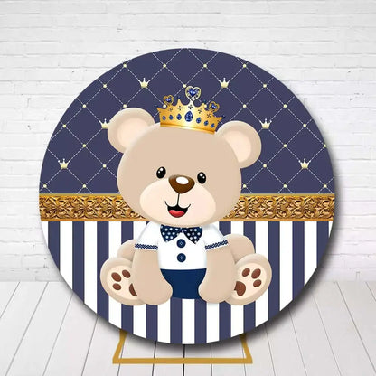 Baby boy’s birthday party backdrop featuring royal teddy bear in navy blue and gold