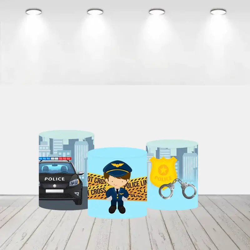 Set of three cylinder covers with a police patrol car, police badge with handcuffs, and a cartoon police officer design, all set against a light blue background.