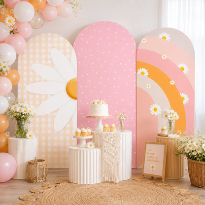 Pastel daisy party set with three arch backdrop covers featuring a large white daisy, pink polka dots, gingham pattern and retro rainbow floral designs.