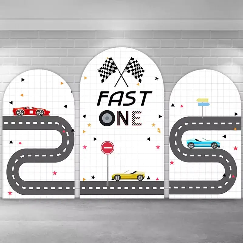Race-themed arch trio featuring graphic roadways, red, yellow, and blue cars, grid background patterns, and playful confetti shapes—ideal for a car-loving toddler’s first birthday.