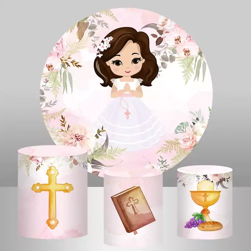 A first communion-themed party decor set with a round floral backdrop featuring a girl in a white dress holding a rosary, paired with cylinder covers displaying a golden cross, a Bible, and a chalice with bread and grapes