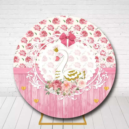 Pink and gold swan round backdrop with flowers for birthday or baby shower