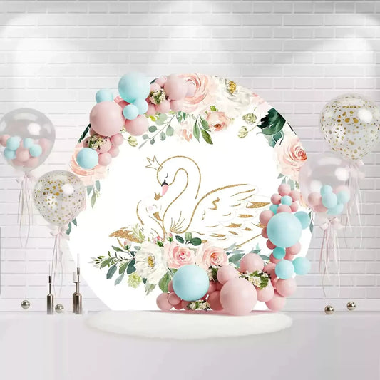 Round baby shower backdrop with a golden swan surrounded by pink and white roses and greenery