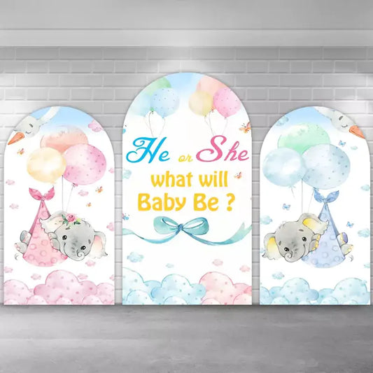 Three-piece gender reveal backdrop set with baby elephants carried by balloons, pastel clouds, and a center arch reading ‘He or She, what will Baby Be?’ in colorful lettering.