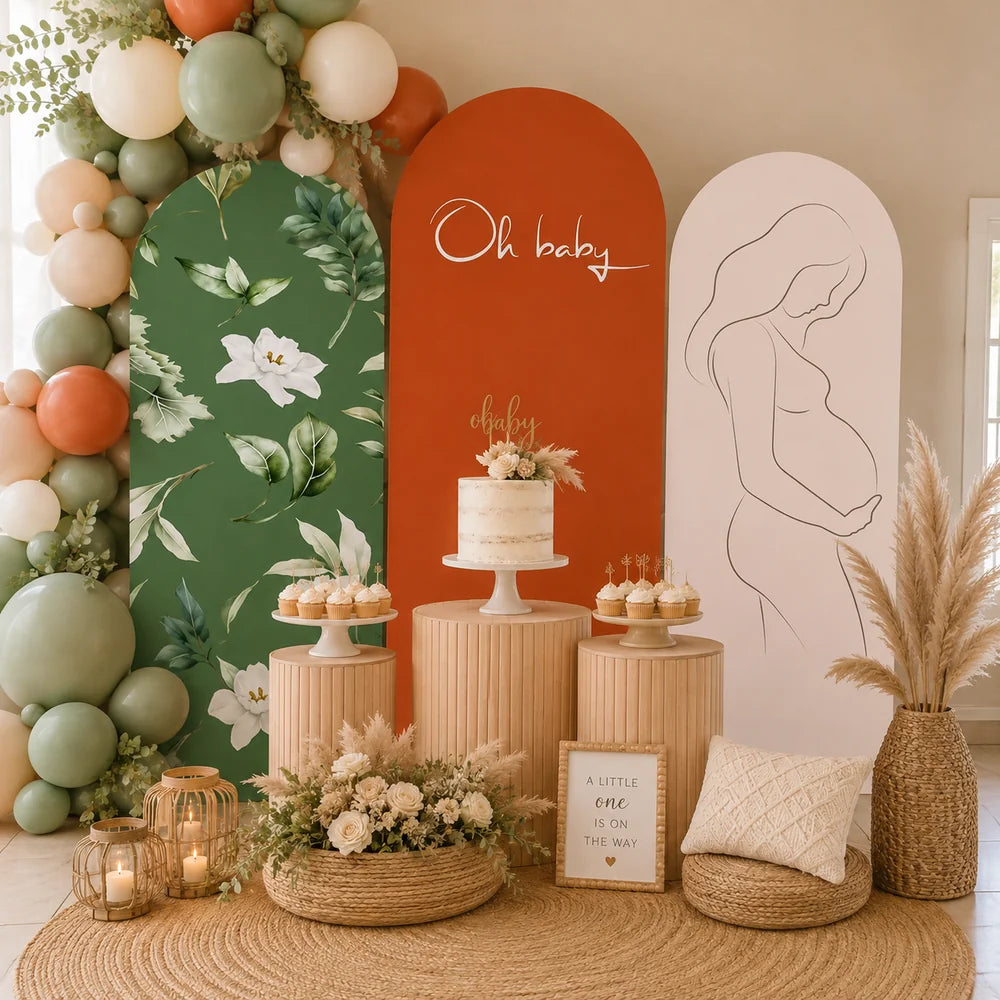 Boho baby shower set with three arch backdrop covers featuring green botanical florals, terracotta Oh Baby lettering and a minimalist pregnant woman line drawing.