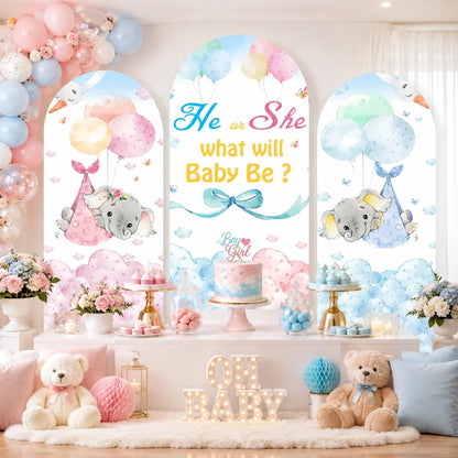 Pink and blue elephant gender reveal set with three arch backdrop covers featuring He or She What Will Baby Be lettering, balloons, clouds and baby elephant designs.