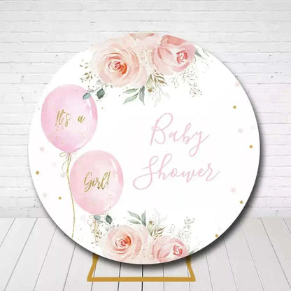 Baby shower backdrop with floral accents and 'It's a Girl' balloons in pink and gold colors