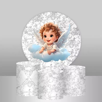 Round backdrop with curly haired baby angel sitting on a blue cloud over white floral pattern