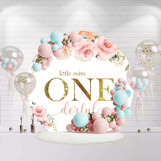 Round floral backdrop with pink roses and Little Miss ONEderful text for first birthday party