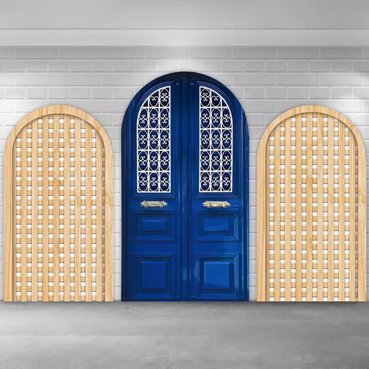 Mediterranean villa–style backdrop set including a bold cobalt arched door and two minimalist wood trellis arches, ideal for photo booths, engagement parties, and outdoor-themed celebrations.