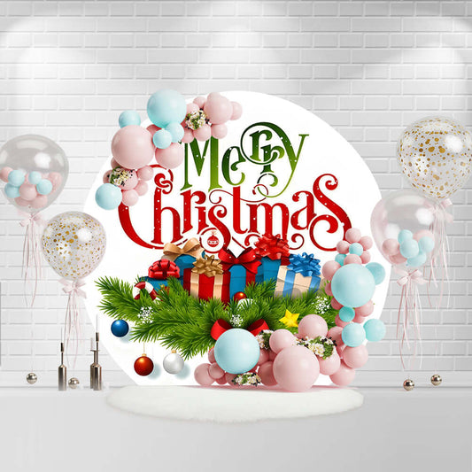 Round Merry Christmas backdrop with gifts, ornaments, and pine branches.
