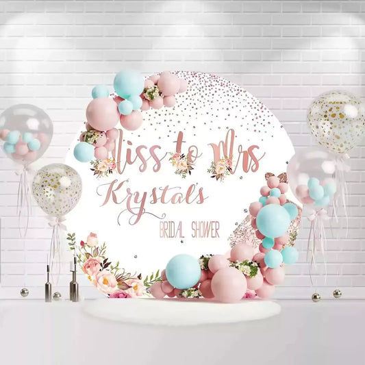 Rose gold Miss to Mrs bridal shower backdrop with floral decorations and glitter dress design