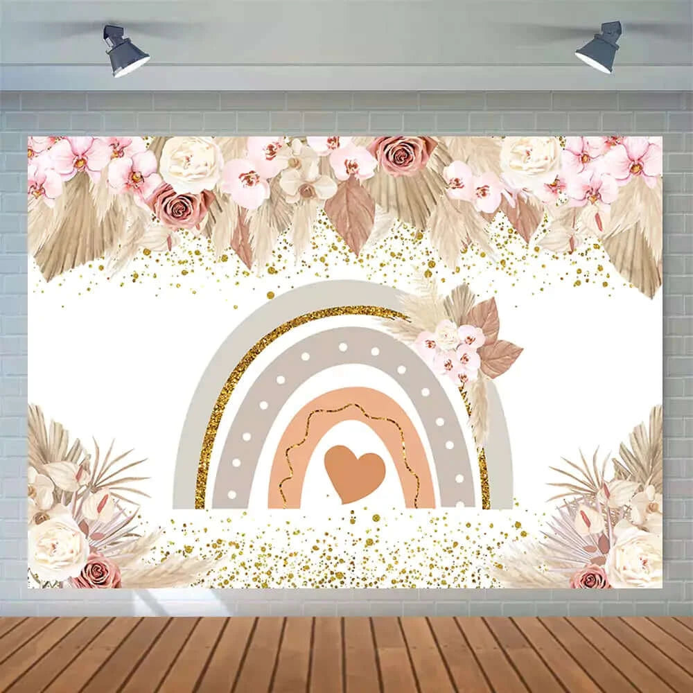 Neutral bohemian rainbow backdrop with dried palm leaves and floral details for party decoration