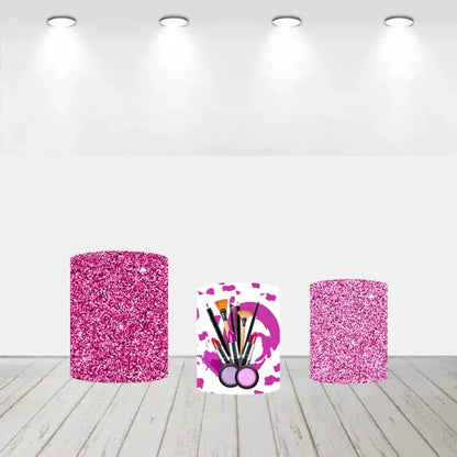 A set of three pink-themed cylinder covers, two featuring pink glitter designs and one displaying makeup brushes, lipsticks, and vibrant pink patterns.