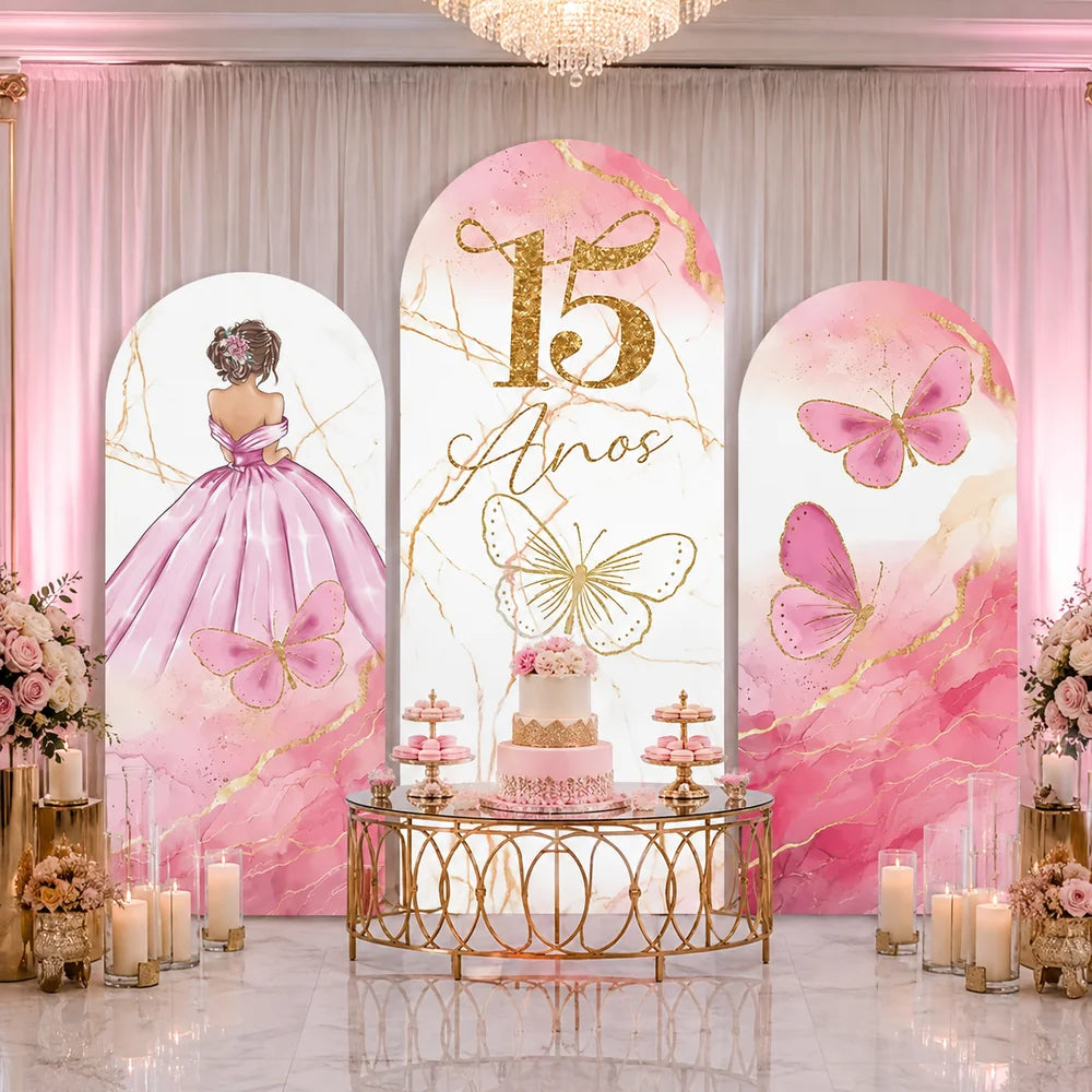 Pink quinceañera party set with three arch backdrop covers featuring a girl in a pink ball gown, gold 15 Años lettering, butterflies and pink marble accents.