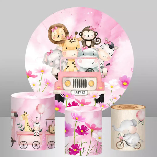 A safari-themed pink party decor set featuring a round backdrop with cute safari animals in a pink jeep, surrounded by pink flowers, and three cylinder covers with matching safari and floral designs.