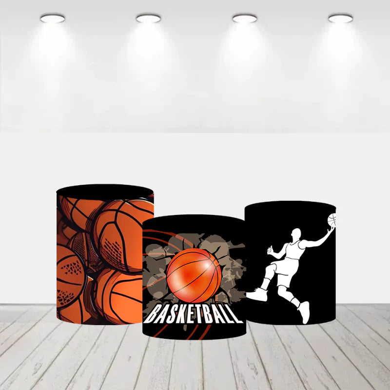 Set of three basketball-themed cylinder covers with various designs. Left cylinder cover with multiple basketballs design. Center cylinder cover with a basketball and the word 'Basketball' in bold letters. Right cylinder cover with a silhouette of a basketball player dunking.