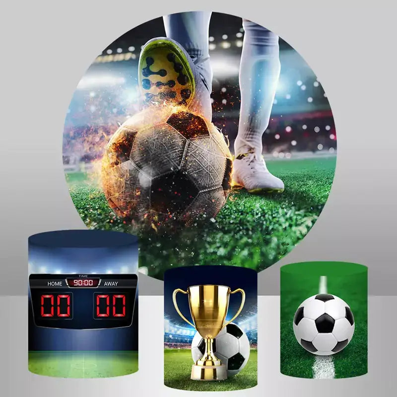 A soccer-themed party decor set featuring a round backdrop with a flaming soccer ball in a stadium and cylinder covers displaying a scoreboard, a golden trophy with a soccer ball, and a soccer ball on a field.