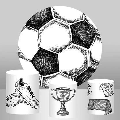 Soccer-themed party backdrop set featuring a large round backdrop with a soccer ball design and three cylinder covers with soccer illustrations of shoes, a trophy, and a goalpost.