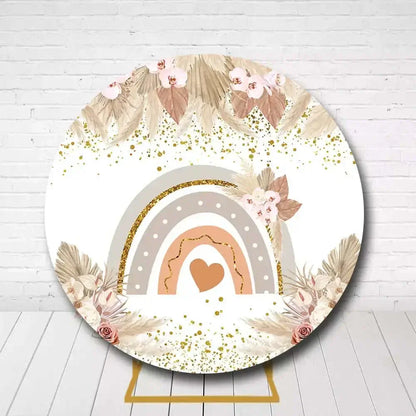 Boho-style rainbow backdrop for baby shower with floral and gold accents
