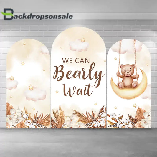 Teddy bear-themed baby shower arch backdrop set with three panels featuring soft beige tones, clouds, stars, floral designs, and the text "We Can Bearly Wait."