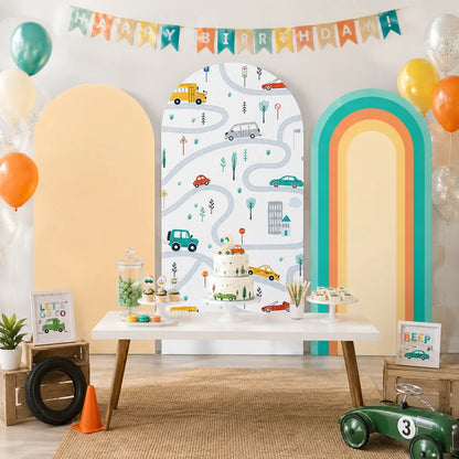 Kids transportation party set with three arch backdrop covers featuring colorful cars, winding roads, traffic signs, a warm peach panel and a retro rainbow arch design.