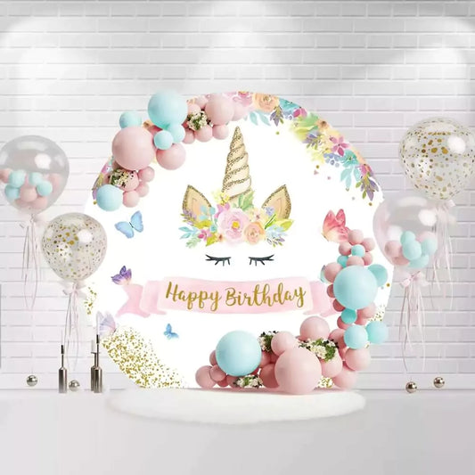Round unicorn birthday backdrop with golden horn, floral wreath, and butterflies