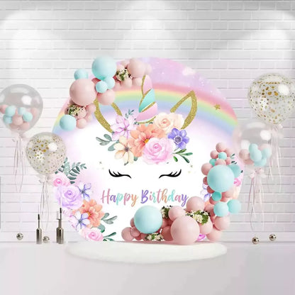 Unicorn birthday round backdrop with pastel rainbow, gold horn, and floral accents