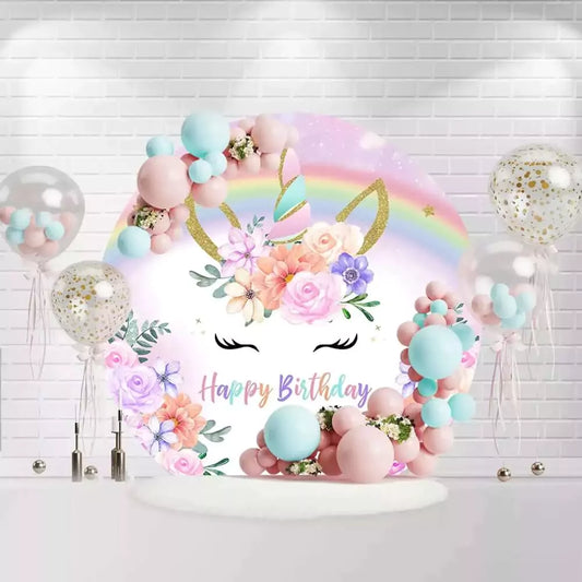 Unicorn birthday round backdrop with pastel rainbow, gold horn, and floral accents